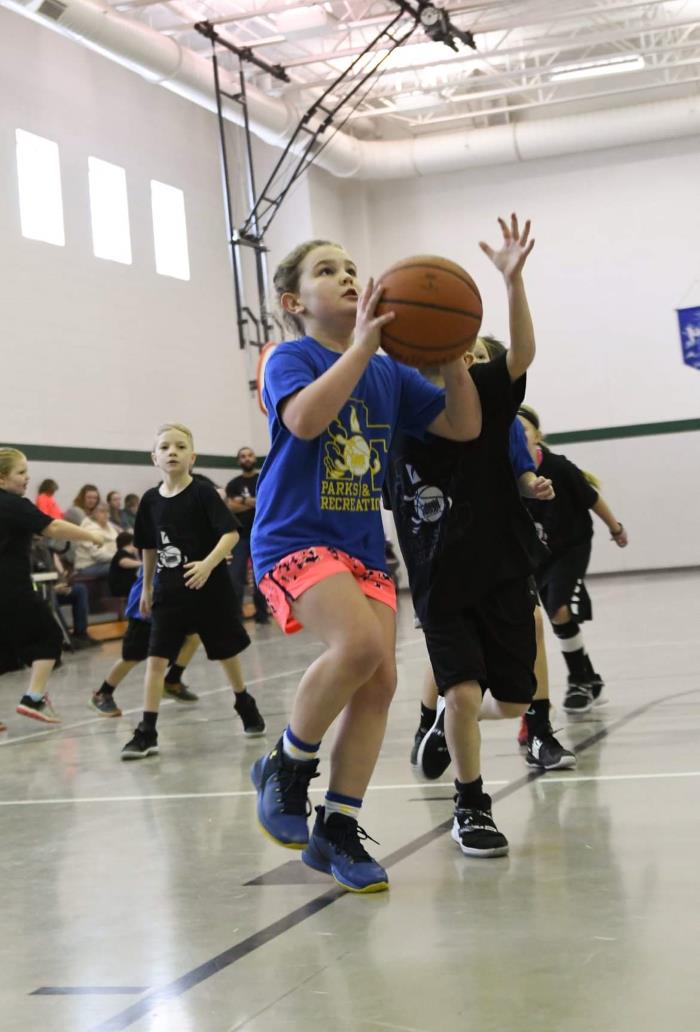 girl shooting a basketball